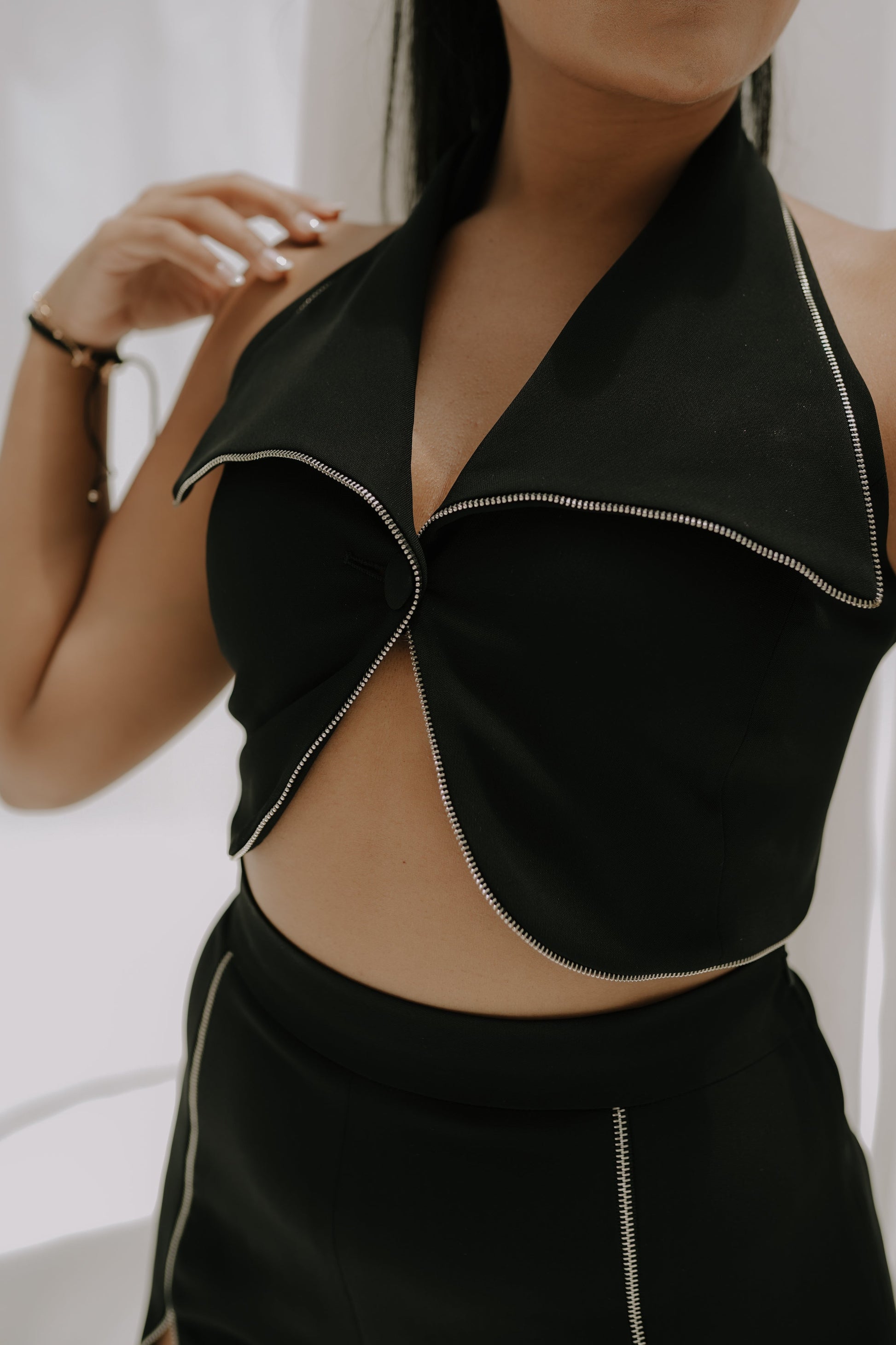 Girl wearing a black party dress with Bell bottom pants paired with a tight fit crop top