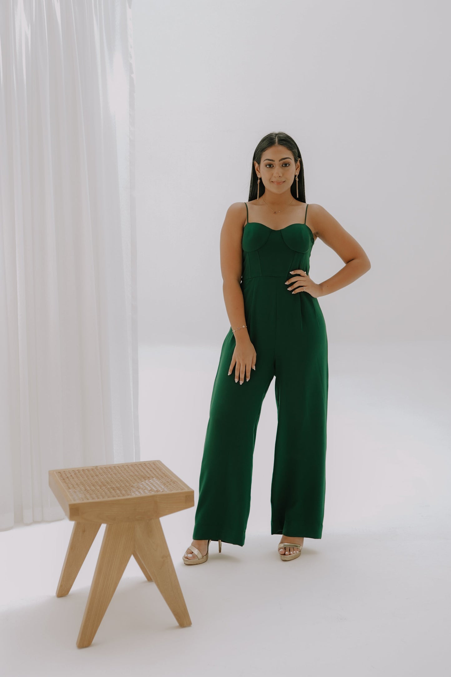 Girl  standing in a dark green corset jumpsuit