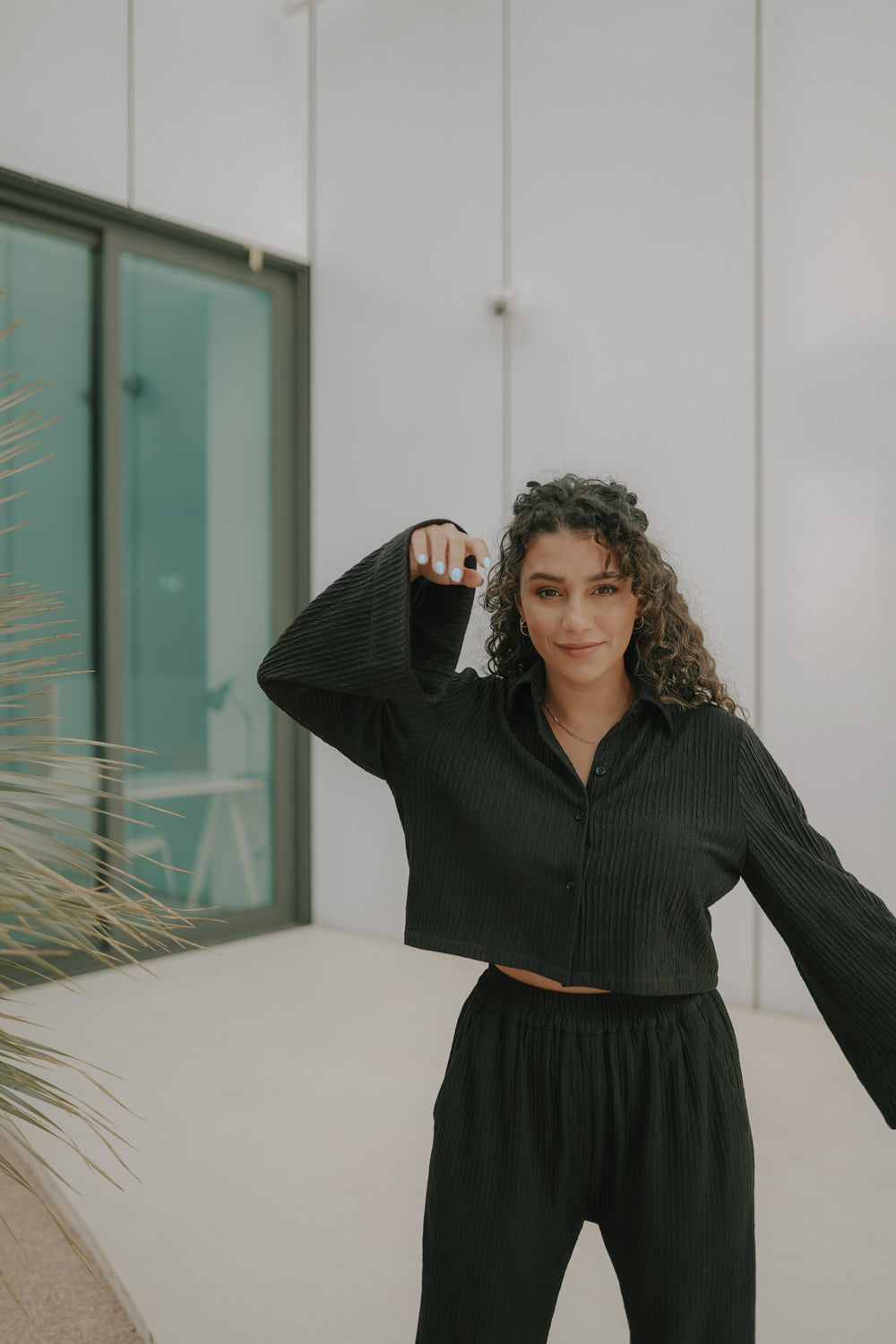 Girl posing in a black coloured best Women loungewear from Embody