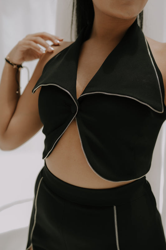 Girl wearing a black party dress with Bell bottom pants paired with a tight fit crop top 