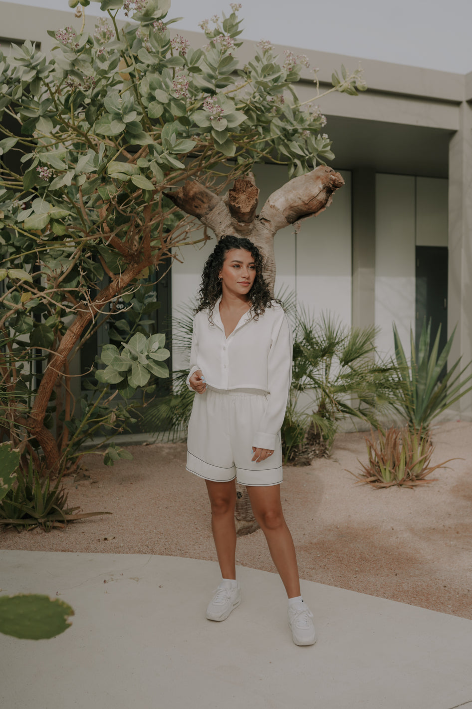 Girl posing in a oversized white shirt and shorts